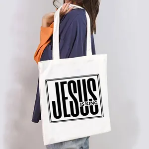 Stylish white canvas tote bag for women featuring a bold black Jesus Is King graphic print