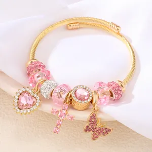 Eleganter goldener Edelstahl-Armreif mit rosa Kristall-Herz-, Kreuz- und Schmetterling