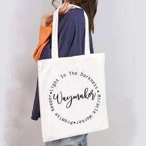 White canvas tote bag with Waymaker print held by a person in a lifestyle setting