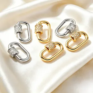 Macro detail of oval copper screw lock pendants featuring pave cubic zirconia in gold and silver