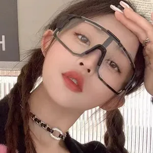 Model wearing oversized windproof cycling sunglasses with transparent grey lenses