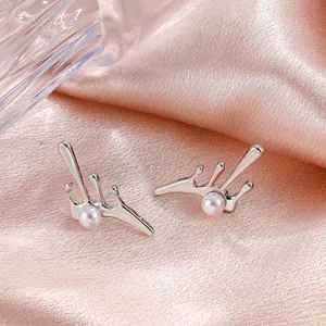 Elegant silver lava pearl earrings with minimalist irregular design on pink silk background
