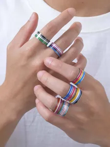 Detail view of various colorful striped enamel rings displayed on fingers for daily wear