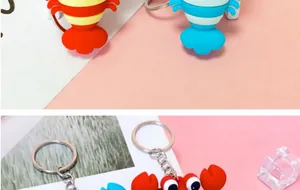 Detailed close-up showing colorful 3D cartoon crab and lobster soft rubber keychains