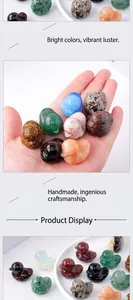 Close-up of various natural stone carved duck figurines in vibrant colors held in a palm