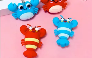 Detailed macro view of colorful cartoon crab and lobster silicone bag charm keychains