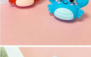 Detailed macro shot of cute 3D cartoon silicone crab charms in vibrant blue and red colors