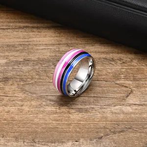 Macro close-up view of a stainless steel ring with vibrant colorful stripes on wood