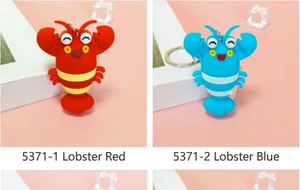 Close-up of cute red and blue cartoon lobster keychains for bags, keys or gifts