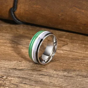 Detailed view of a silver ring featuring vibrant green, white, blue, and black stripes.