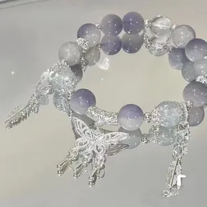 Elegant purple and clear bead bracelet featuring a detailed silver butterfly charm.
