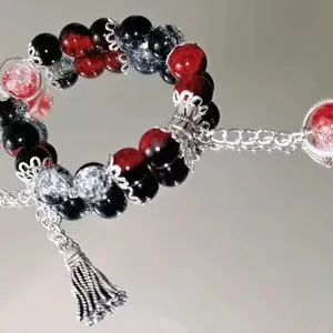 Handmade red and black beaded bracelet with elegant silver tassel for women