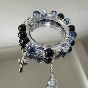Elegant blue and black beaded bracelet with cross charm and silver chain detail