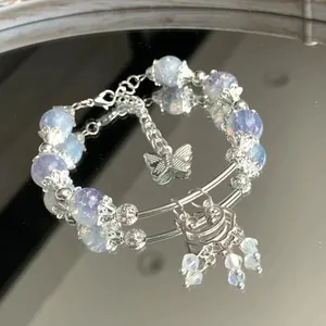 Elegant light blue beaded bracelet with silver butterfly and traditional lock charms