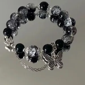 Handmade black and silver cracked glass beaded bracelet with butterfly charms