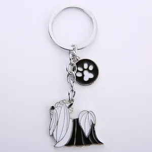 Creatieve metalen sleutelhanger met zwart-witte emaille hond en pootafdruk hanger