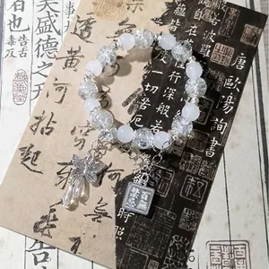 Elegant national style beaded bracelet featuring white beads and a silver butterfly charm