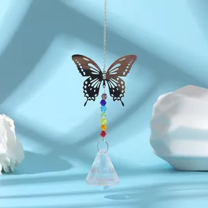 Close-up of a silver butterfly suncatcher with rainbow beads and crystal pendant