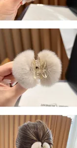 Detailed close-up showing the soft plush texture of a small fur ball hair claw clip.