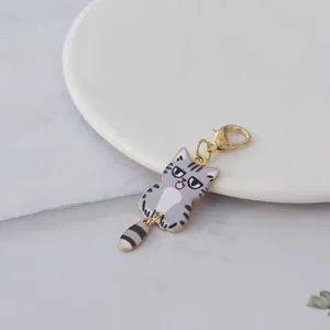 Detailed view of a cute grey tabby cat charm with a grumpy expression and gold clasp.