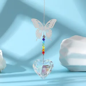 Close-up of a silver butterfly suncatcher with rainbow beads and heart crystal prism