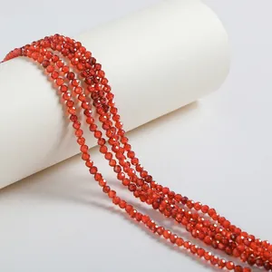 Close-up detail of small red faceted zircon beads for DIY jewelry making accessories