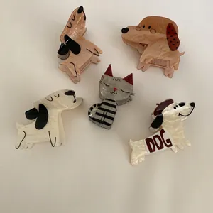 Cute acetate hair claw clips featuring various dog and cat designs on beige background