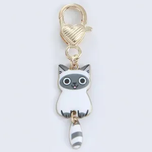 Cute cartoon Siamese cat keychain with gold heart clasp and dangling striped tail