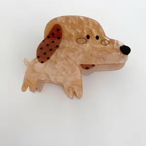 Detailed view of a cute cartoon dog shaped hair claw clip with marble texture