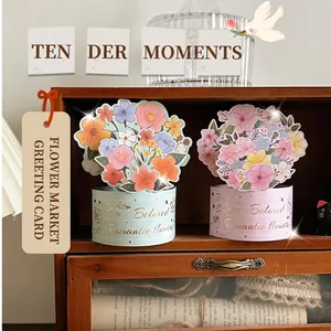 Detailed view of 3D bouquet greeting cards with Romantic flowers text on a wooden shelf
