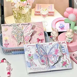 Close-up of decorative 3D butterfly pop-up greeting cards in a soft pink scene