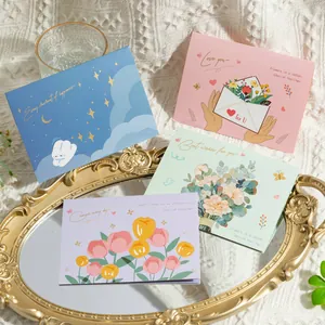 Close-up of four romantic floral greeting cards with elegant gold-embossed details