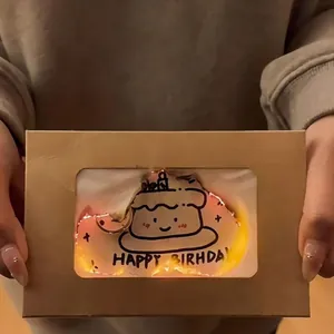 Detail close-up of a creative burning birthday card showing a hidden ring surprise inside.