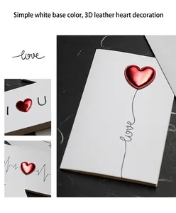 Detailed view of 3D metallic red leather heart on minimalist white greeting card