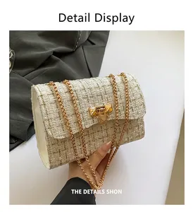 Detailed view of a cream tweed crossbody bag with elegant gold chain straps and lock.