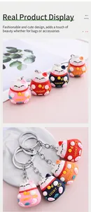 Close-up view of four colorful 3D Maneki-neko Lucky Cat cartoon silicone keychains