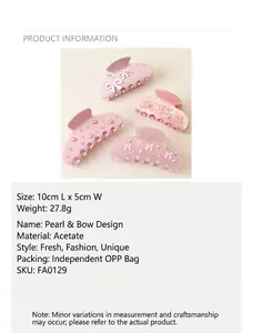 Product detail view of pink acetate hair claw set with pearl bow and rhinestone