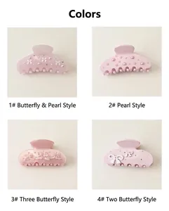 Detailed view of four pink acetate hair claw clips with pearl and bow decorations.