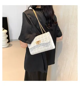 Elegant white tweed shoulder bag with gold chain strap and textured fabric finish
