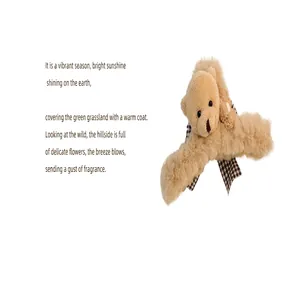 Close-up detail of the plush bear hair claw clip featuring soft faux fur and plaid bow.