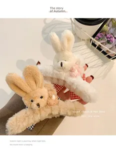 Close-up of cute plush rabbit hair claw clips featuring ribbon and knit flower details.