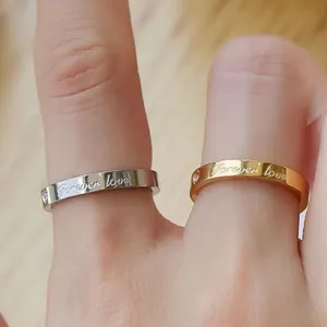 Couple rings with Forever love engraving in polished gold and silver stainless steel