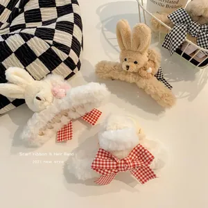 Plush rabbit hair claw clips with checkered ribbon bows in cream and beige colors