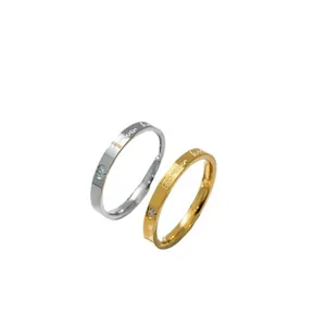 Detail shot of silver and gold rings featuring 'Forever love' engraving and heart detail
