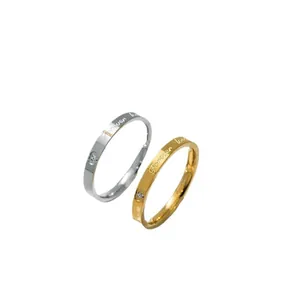 Elegant gold and silver couple rings engraved with Forever Love and sparkling crystal accents