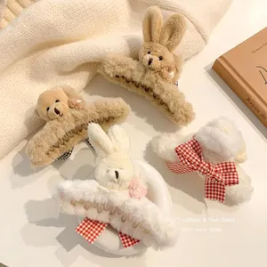 Detail view of plush bear and rabbit hair claws with plaid ribbon accents for winter