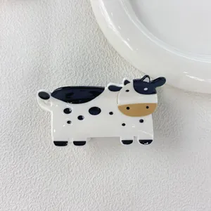 Close-up of a cute cow-shaped hair claw clip made of high-quality acetate material
