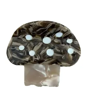 Cute mushroom shaped hair clip featuring brown marble acetate and white polka dots