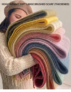 Close-up showing the soft texture and thick volume of various colored plush scarves