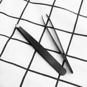 Macro-detail of black stainless steel tweezers with slanted and pointed tips